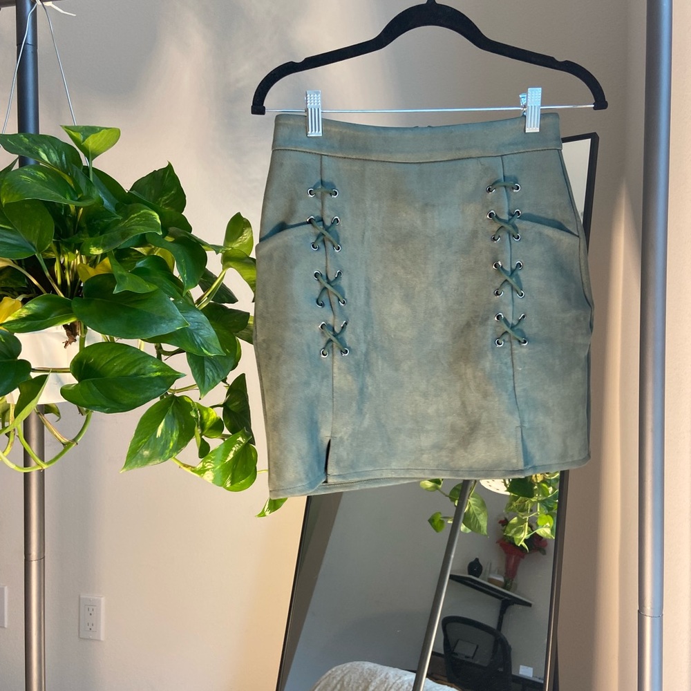 Olive green suede miniskirt with trendy & cute cross ties on the front.